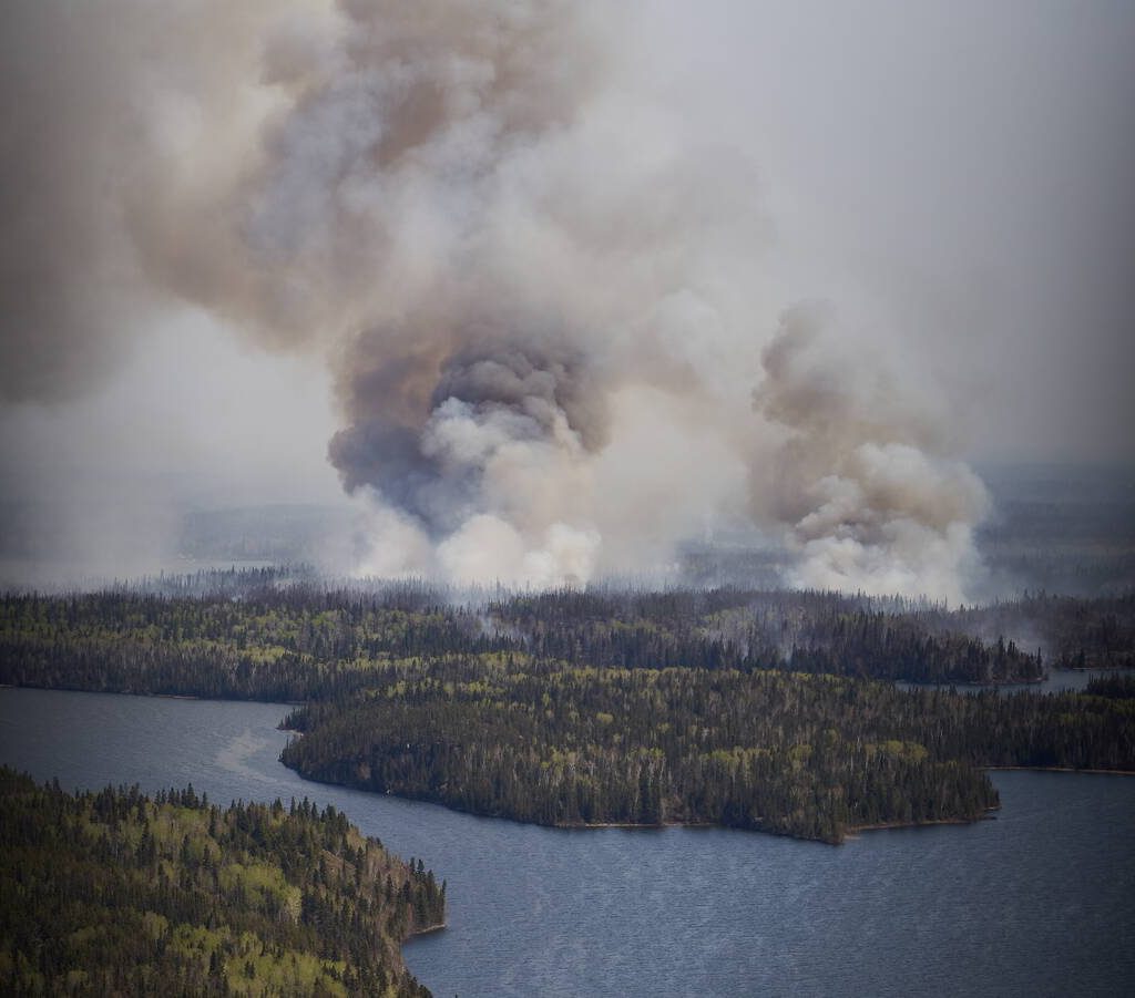 May 14, 2024, Flin Flon, Mb, CANADA: A wildfire burns in northern Manitoba near Flin Flon, as seen from a helicopter surveying the situation, Tuesday, May 14, 2024. (Credit Image:  David Lipnowski/The Canadian Press via ZUMA Press)