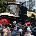 A golden farming tractor featuring the signatures of Trump Administration cabinet members is displayed during an event celebrating farmers and Agriculture Day on the South Lawn of the White House in Washington DC on Friday, March 27, 2026.