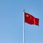 The flag of China flying against a blue sky. Beijing still has a 25 per cent duty on imports of Canadian pork, which Champagne said he raised during the meetings.