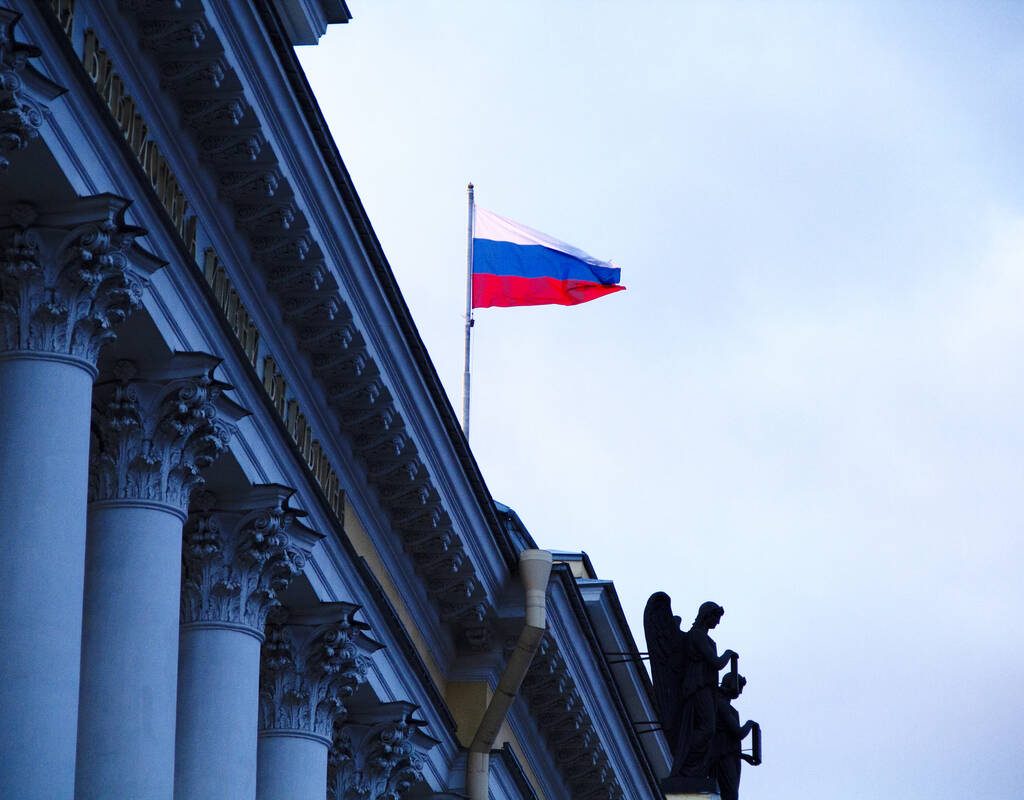 The Russian flag flies on the top of a building in Senate Square in Saint Petersburg, Russia at sunset. Photo: Anna Linda Knoll/Getty Images Plus