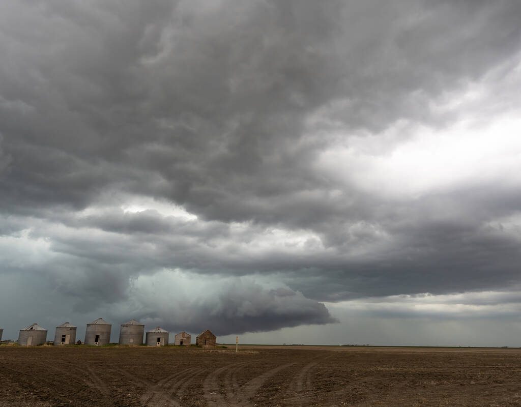 Old granaries standing in a stubble field with an ominous sky of grey clouds. This week’s Prairie forecast shows several storm systems are setting up across the Prairies with potential for rain, freezing rain and snow.