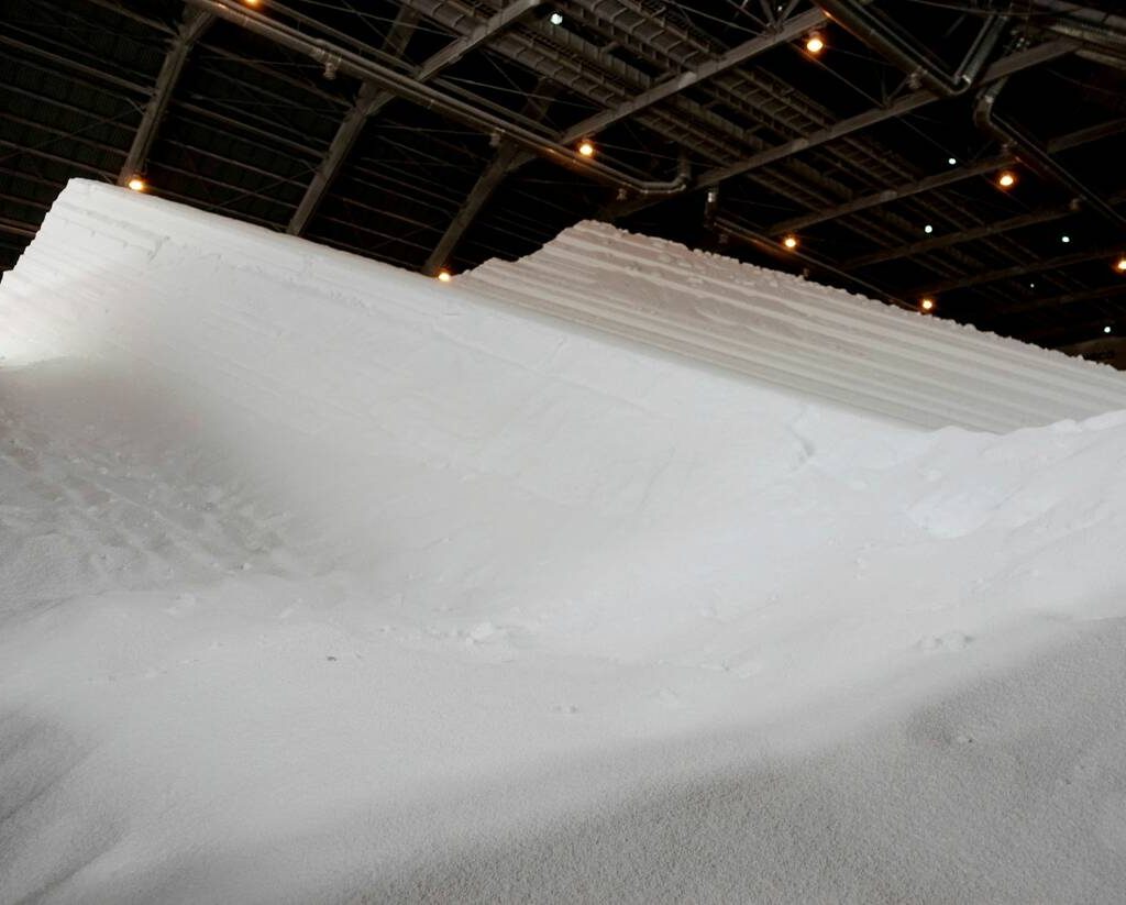 Heaps of granulated white urea in a storage facility.