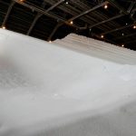 Heaps of granulated white urea in a storage facility.