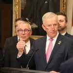MP David Bexte speaks with reporters in Ottawa on April 15. He is surrounded by supporters.