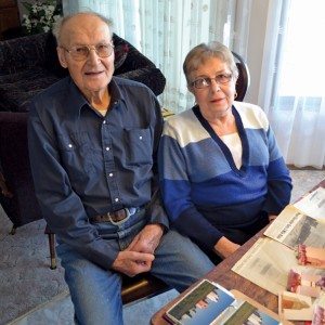 Bernard Lentz and wife Irma look over old newspaper articles from 1978 when they moved the pioneer Menaik grain elevator to their former farm.