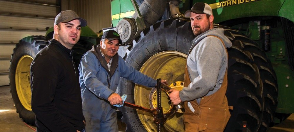 “Our repairs dropped $5 an acre this year… I was ecstatic.” – Kristjan Hebert, shown above with father Louis and team member Bryce Olsen.